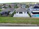 Aerial shot showcasing a patio, lush lawn, and tranquil lake views at 10008 Celtic Ash Dr, Ruskin, FL 33573