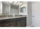 Bathroom featuring double sinks, granite countertops and modern fixtures at 10008 Celtic Ash Dr, Ruskin, FL 33573