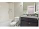 Bathroom featuring granite vanity top, tile flooring, tiled walls, and a shower-tub combo at 10008 Celtic Ash Dr, Ruskin, FL 33573