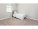 Bright bedroom featuring a single bed and stylish glass side table by the window at 10008 Celtic Ash Dr, Ruskin, FL 33573