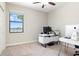 Bedroom setup as an office with a view of the lake and modern furniture at 10008 Celtic Ash Dr, Ruskin, FL 33573