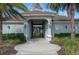 Inviting clubhouse entrance with lush landscaping and elegant architectural details, creating a welcoming ambiance at 10008 Celtic Ash Dr, Ruskin, FL 33573