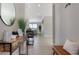 Bright hallway with tile flooring, leading to a living area with scenic lake view at 10008 Celtic Ash Dr, Ruskin, FL 33573