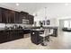 Kitchen featuring stainless steel appliances, dark wood cabinetry, granite countertops, and a center island at 10008 Celtic Ash Dr, Ruskin, FL 33573