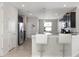 Stylish kitchen with stainless steel appliances, granite countertops, and modern white barstools at 10008 Celtic Ash Dr, Ruskin, FL 33573