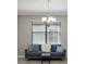 Cozy living room featuring a modern couch, stylish pillows, and natural light at 10008 Celtic Ash Dr, Ruskin, FL 33573