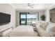A bright living room with a large sliding glass door offering views of the patio and lake at 10008 Celtic Ash Dr, Ruskin, FL 33573