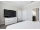 Spacious main bedroom featuring a large TV and ensuite bathroom at 10008 Celtic Ash Dr, Ruskin, FL 33573