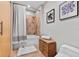 Clean bathroom features shower over tub, decor and wood floors, tiled walls and wood door at 101 N 12Th St # 206, Tampa, FL 33602