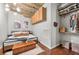 Comfortable bedroom showcases exposed ceiling pipes, hardwood floors, closet and wooden storage over the bed at 101 N 12Th St # 206, Tampa, FL 33602