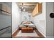 Modern bedroom featuring exposed ductwork, wood floors, trunk at foot of bed and unique lighting fixture at 101 N 12Th St # 206, Tampa, FL 33602