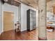 Hallway with hardwood floors, concrete pillars and glass display case that provides access to the bedroom at 101 N 12Th St # 206, Tampa, FL 33602