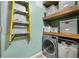 Practical laundry room with shelving and an updated washing machine at 101 N 12Th St # 206, Tampa, FL 33602