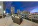 Outdoor patio at dusk features contemporary seating, lounge furniture and a beautiful city view at 101 N 12Th St # 206, Tampa, FL 33602