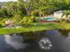 Aerial view of amenities featuring a community pool, gazebo, and pond with fountain at 11260 Kapok Grand Cir, Madeira Beach, FL 33708