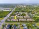 High aerial shot of the neighborhood with townhomes, landscaping, and nearby highway access at 11260 Kapok Grand Cir, Madeira Beach, FL 33708