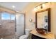 Bathroom featuring glass enclosed shower, sink with unique design, and decorative lighting at 11260 Kapok Grand Cir, Madeira Beach, FL 33708