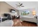 Bright bedroom features a ceiling fan, a large window, and a dedicated workspace for studying or working from home at 11260 Kapok Grand Cir, Madeira Beach, FL 33708
