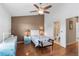 Comfortable bedroom with ceiling fan, ensuite bath, and stylish furnishings at 11260 Kapok Grand Cir, Madeira Beach, FL 33708