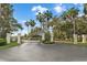 Gated community entrance with meticulously maintained landscaping at 11260 Kapok Grand Cir, Madeira Beach, FL 33708