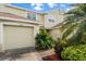 Well-maintained home with a neatly kept lawn and a classic garage door at 11260 Kapok Grand Cir, Madeira Beach, FL 33708