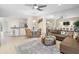 Open-concept living room and dining area with tile floors and neutral decor at 11260 Kapok Grand Cir, Madeira Beach, FL 33708