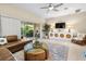 Relaxing living room with access to the outdoors and comfortable furnishings at 11260 Kapok Grand Cir, Madeira Beach, FL 33708