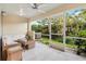 Inviting screened patio with comfortable seating and views of the lush greenery at 11260 Kapok Grand Cir, Madeira Beach, FL 33708
