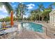 Community pool with lounging chairs and nearby patio furniture at 11260 Kapok Grand Cir, Madeira Beach, FL 33708