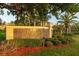 Entrance sign to Kohok Grand surrounded by beautiful shrubbery and colorful foliage at 11260 Kapok Grand Cir, Madeira Beach, FL 33708