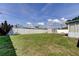 Large back yard with grass, a privacy fence, and an outbuilding at 11487 80Th Ave, Seminole, FL 33772