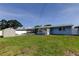 Grassy backyard featuring a shed and screened patio at 11487 80Th Ave, Seminole, FL 33772