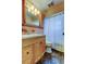 Bathroom features a wood vanity, and shower/tub combo, creating a functional space at 11487 80Th Ave, Seminole, FL 33772