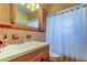 Bathroom boasts vintage tile, a wood vanity, and shower/tub combo, creating a unique and functional space at 11487 80Th Ave, Seminole, FL 33772