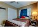 Bedroom with a ceiling fan, closet, and a window offering natural light at 11487 80Th Ave, Seminole, FL 33772