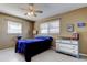 Bright bedroom featuring a ceiling fan, and a large window with natural light at 11487 80Th Ave, Seminole, FL 33772