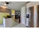 Bright kitchen boasts stainless steel refrigerator and access to living area at 11487 80Th Ave, Seminole, FL 33772