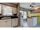 Bright kitchen featuring white cabinets, dark countertops, and breakfast bar at 11487 80Th Ave, Seminole, FL 33772