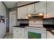 Clean, functional kitchen with white appliances and ample cabinet space at 11487 80Th Ave, Seminole, FL 33772
