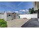 Outbuilding in the back yard with a concrete pad and privacy fence at 11487 80Th Ave, Seminole, FL 33772