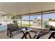 Screened-in patio with furniture, offering a view of the backyard and shed at 11487 80Th Ave, Seminole, FL 33772