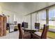 Sunroom area with a glass table, wicker chairs, and lots of natural light from the surrounding windows at 11487 80Th Ave, Seminole, FL 33772