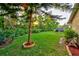 The vast, green backyard, dotted with tall vegetation, is the perfect place to relax and enjoy the sun at 12024 Stone Crossing Cir, Tampa, FL 33635