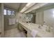 Bright bathroom with double sinks, white cabinetry, and ample counter space at 12024 Stone Crossing Cir, Tampa, FL 33635