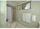 Neat bathroom featuring a tiled shower, toilet, and fresh white towels for a spa-like feel at 12024 Stone Crossing Cir, Tampa, FL 33635