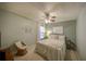 Serene bedroom showcasing a ceiling fan, neutral tones, and a cozy seating area at 12024 Stone Crossing Cir, Tampa, FL 33635