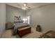 Relaxing bedroom featuring soothing paint, a ceiling fan, and ample natural light from the window at 12024 Stone Crossing Cir, Tampa, FL 33635