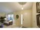 Bright foyer features a white door, tile flooring, and decorative wall art at 12024 Stone Crossing Cir, Tampa, FL 33635
