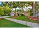 Inviting home showcasing lush green lawn, mature shade trees, and an attached garage for convenient parking at 12024 Stone Crossing Cir, Tampa, FL 33635