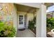 Charming front porch with stone accents, tiled flooring, and lush landscaping at 12024 Stone Crossing Cir, Tampa, FL 33635
